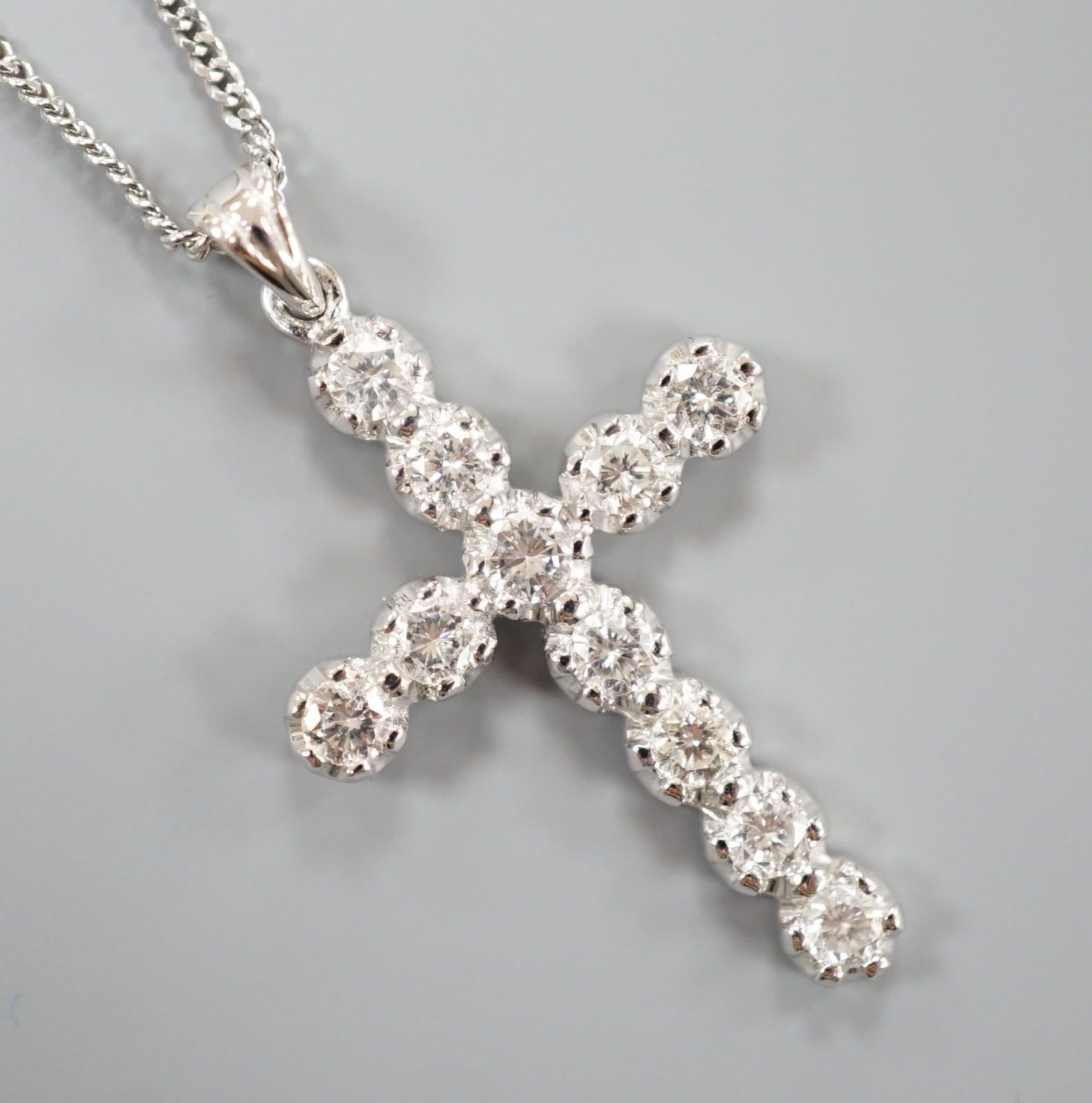 A modern 18ct white gold and diamond set cross pendant, 39mm, on an 18ct white gold chain, 44cm, gross weight 7.1 grams.